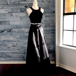 A 2-piece formal black gown with a lace halter style top and full skirt.